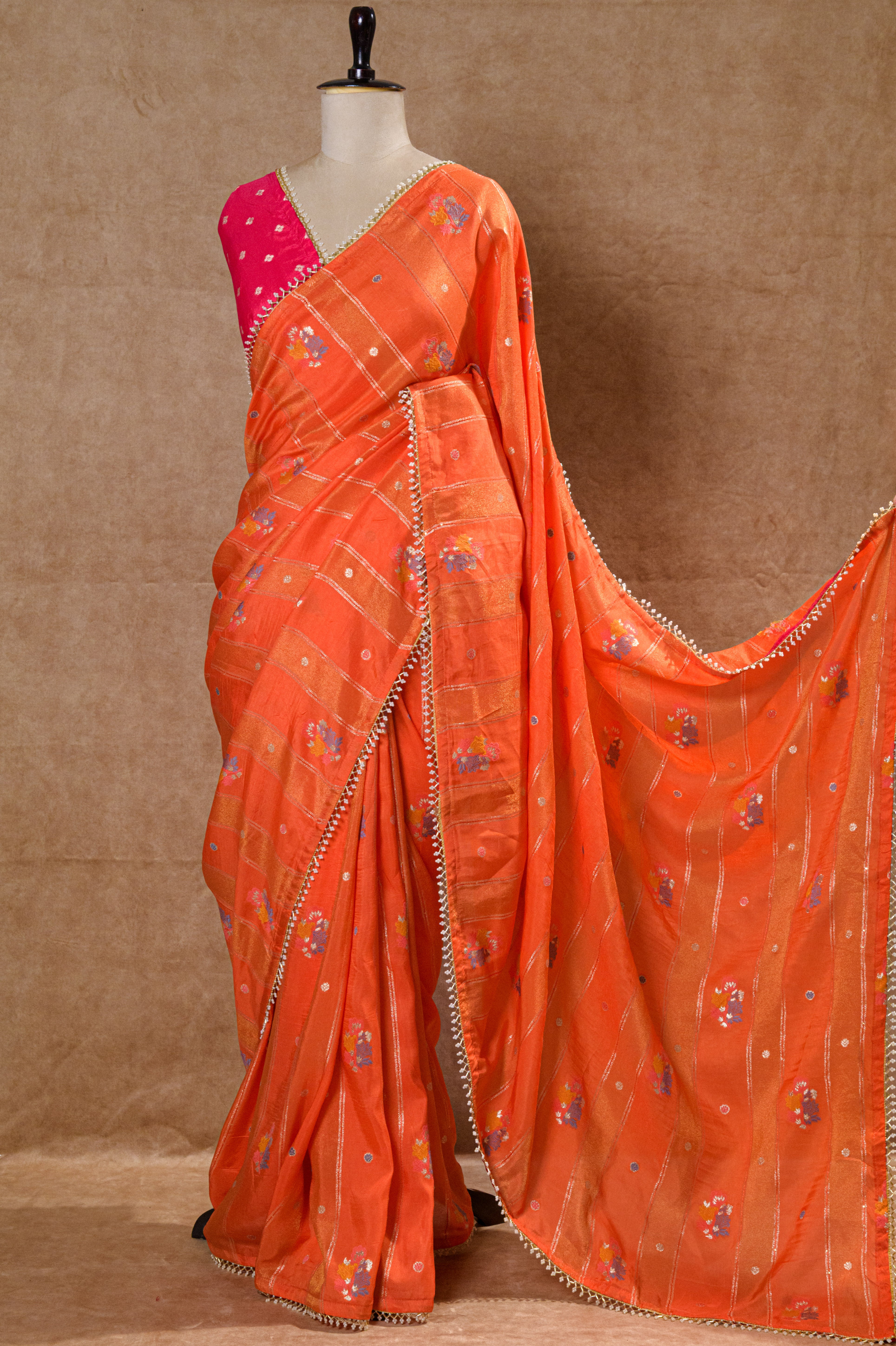 Orange Organza Saree with Rani Pink Handworked Blouse and Kundan Moti Detailing