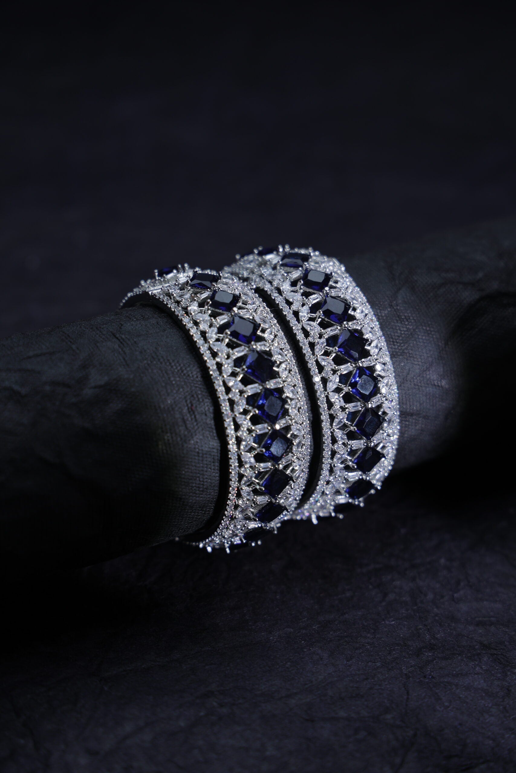 Silver bracelet with blue stones on a dark background